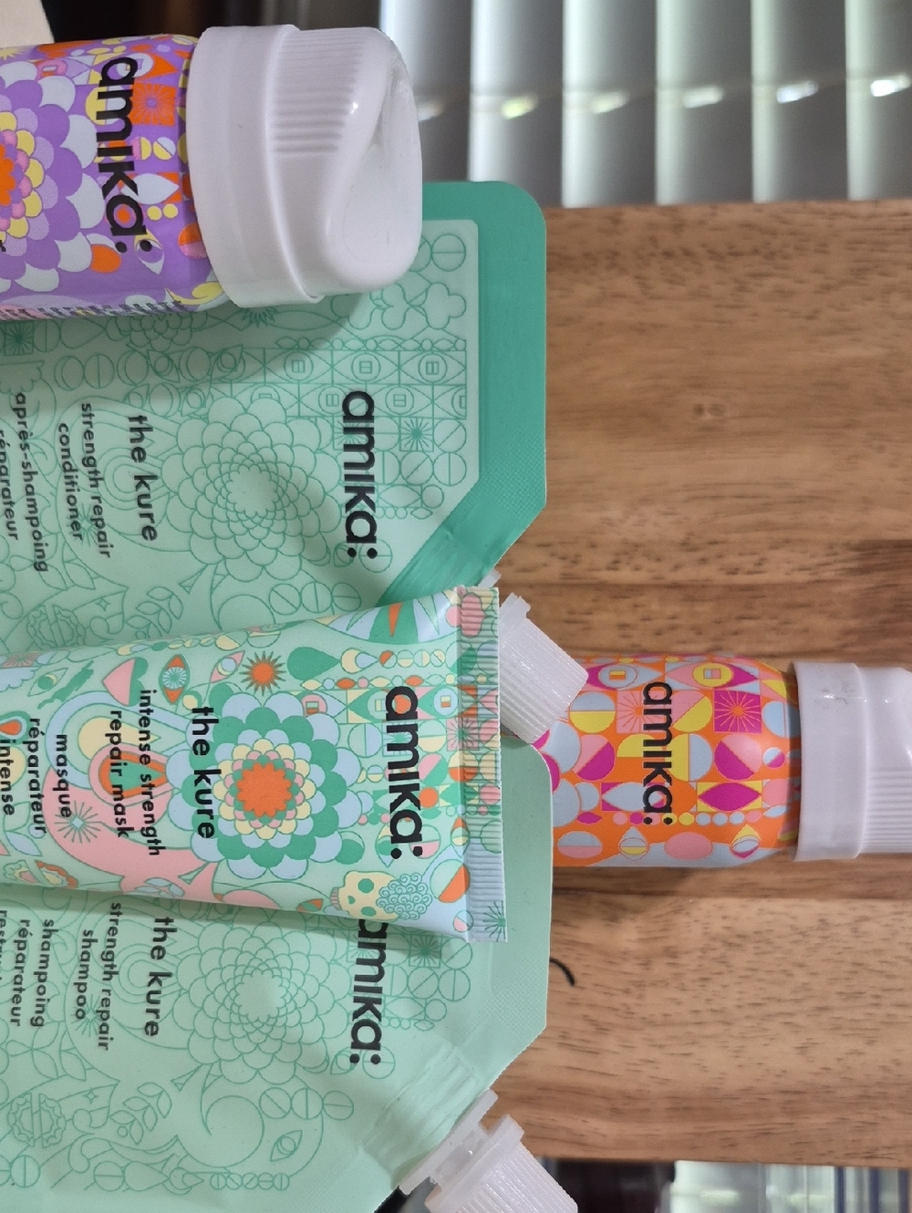 amika hair care set in mint green with pastel multicolor accents